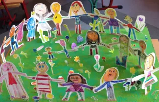 Selbstportraits von Schulkindern aus Pappe ausgeschnitten